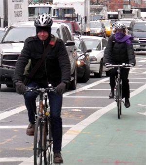 Two cyclists brave the elements to use the Columbus Avenue bike lane on the same frigid day a NY Times reporter observed scant cyclists.